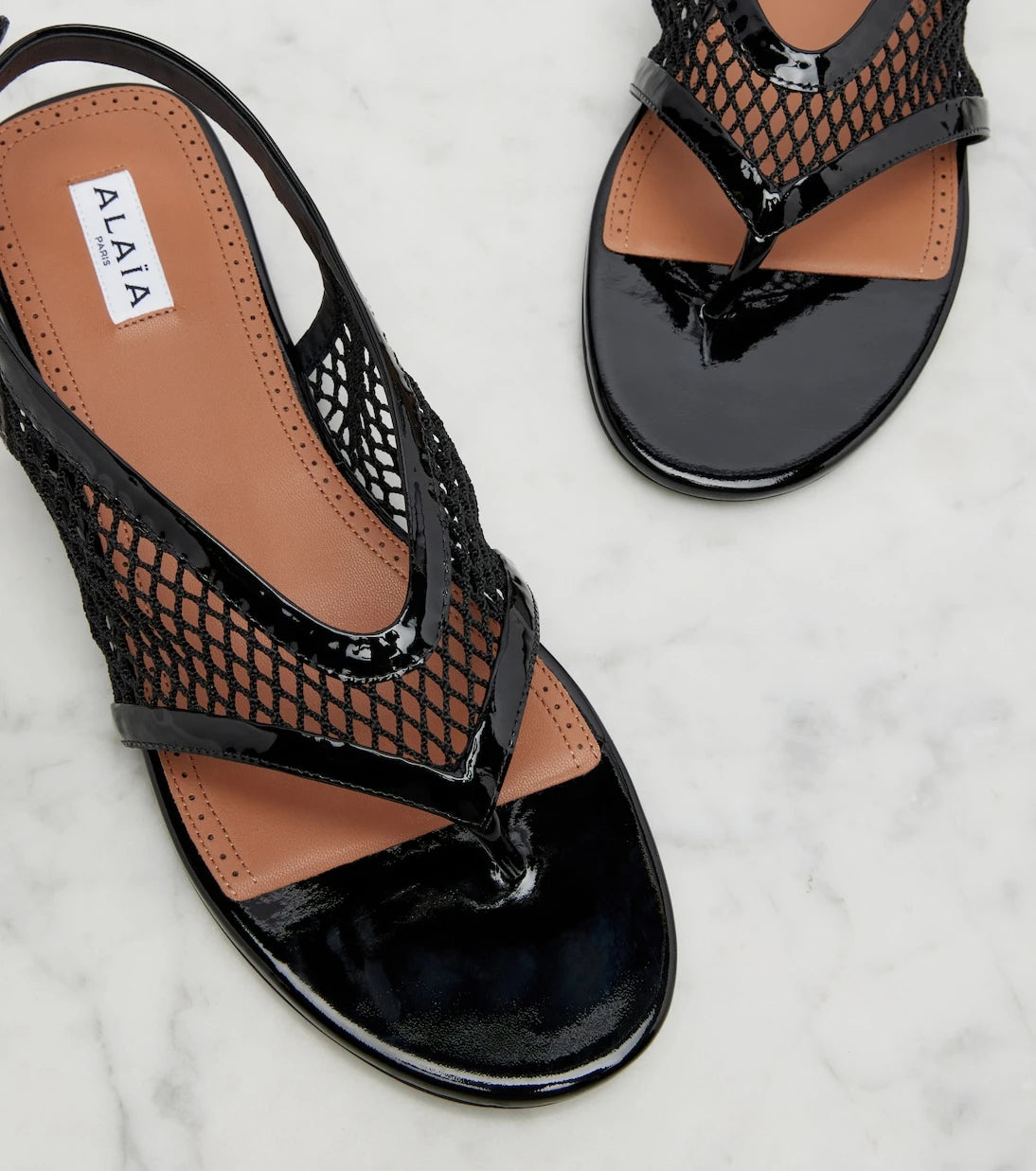 Alaïa - Fishnet leather-trimmed thong sandals