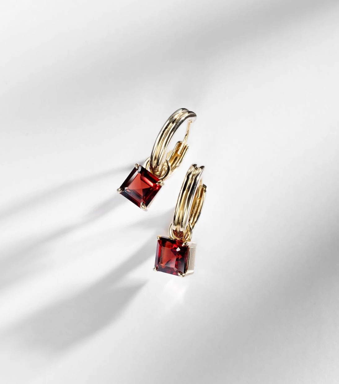 Stone and Strand - 10kt gold earrings with garnets